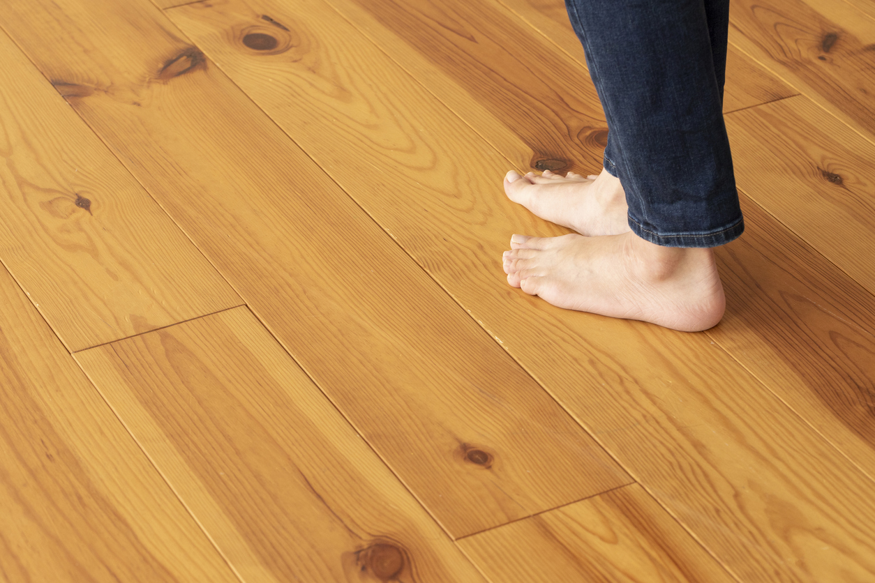 Barefoot woman walking across a squeaky wood floor