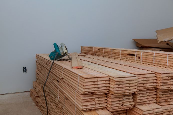 Wood flooring stacked in a room to allow for acclimation